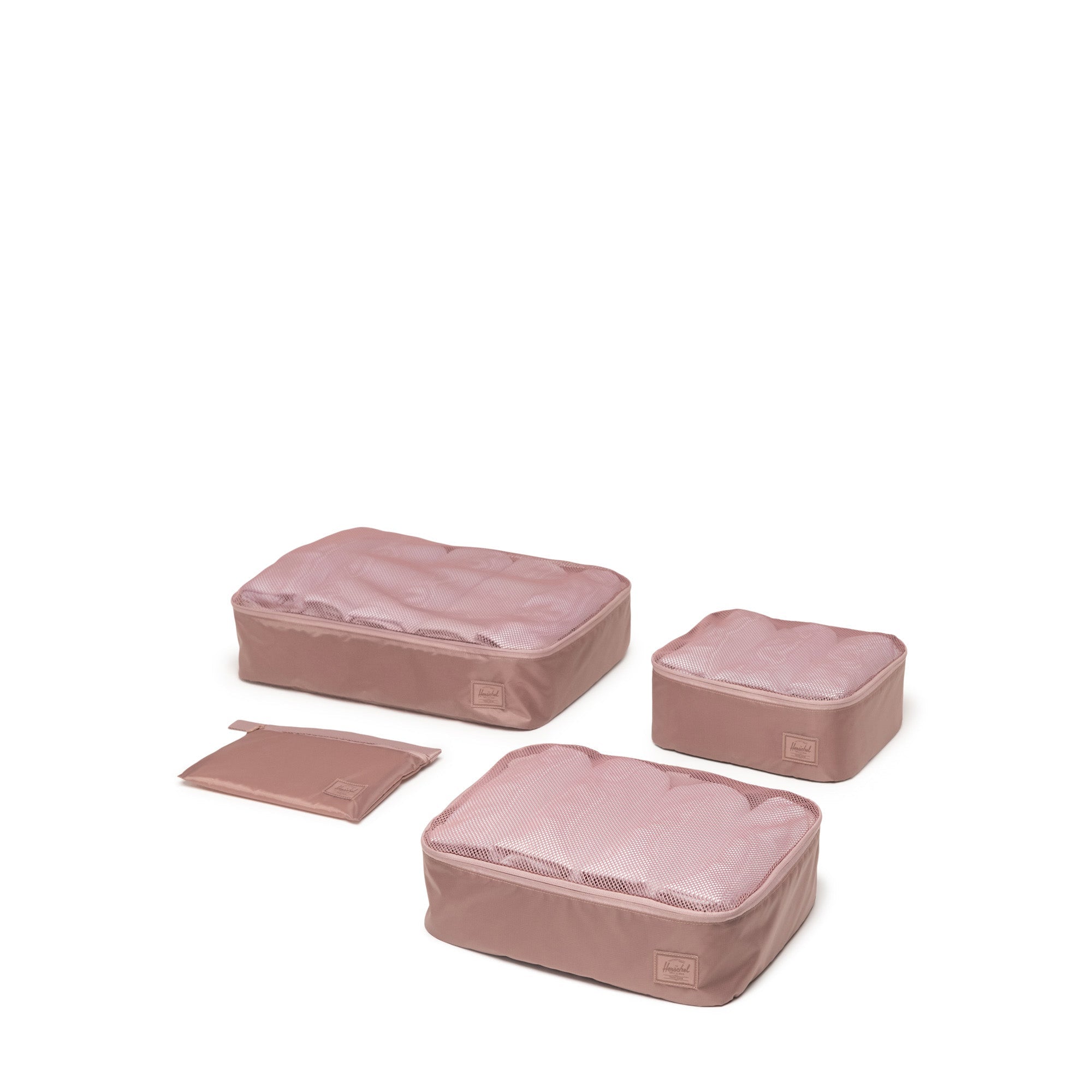 Set of pink packing cubes on a white background